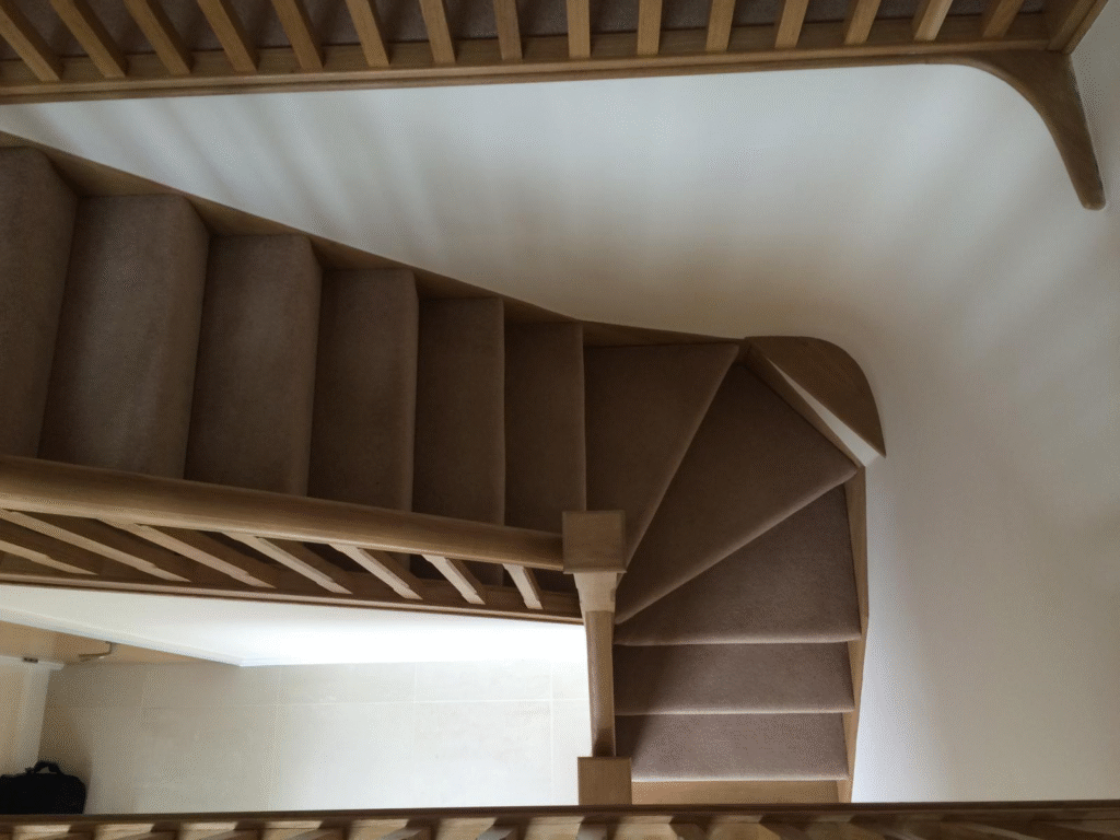 Bespoke oak staircase with carpet runner and winder design, handcrafted by Springfield Stairs in Swadlincote
